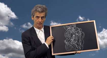 Peter Capaldi holds a chalkboard